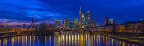 The Frankfurt skyline with office tower blocks behind the Main at blue hour after sunset, on the