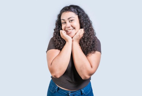 Happy girl face looking and smiling at the camera isolated. Portrait of beautiful girl smiling at