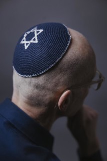 Jewish man wearing a kippa with a Star of David on his head, back view, studio shot, Germany,