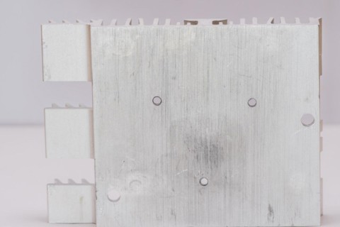 Closeup of mounting surface of rectangle aluminum heat sink on white background