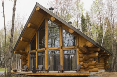 Luxurious Scandinavian style log home with large panoramic windows in spring, Quebec, Canada, North