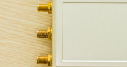 Close-up of gold connectors for antenna ports on beige casing, in South Korea