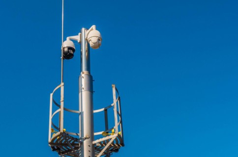 Closed circuit television devices and weather veins on metal pole against blue sky in Daejeon,