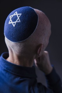 Jewish man wearing a kippa with a Star of David on his head, back view, studio shot, Germany,