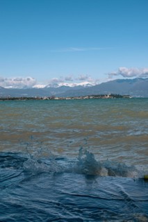 View over the wavy Lake Garda under a blue sky with clouds, Sirmione, Lake Garda, Italy, Europe