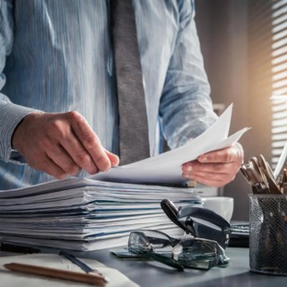 Businessman sorting files at a cluttered desk in an office, symbolism bureaucracy, AI generated, AI