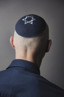 Jewish man wearing a kippa with a Star of David on his head, back view, studio shot, Germany,