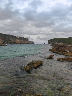 Rocky coast, long bay by the sea at sunset. Dangerous view of the Caribbean Sea. Tropical climate