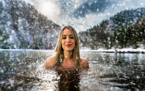 A young pretty woman bathes in an ice-cold lake in snowfall, AI generated, AI generated