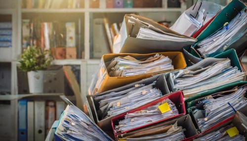 Overflowing filing boxes with lots of papers and folders in one room, bureaucracy symbol, AI