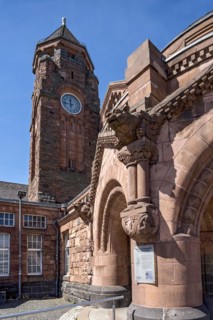 Historic Wilhelmine railway station, clock tower, pavilion with gargoyle, entrance to the station