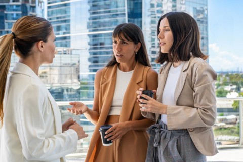 The female boss is informing her two employees that they need to focus on work rather than engaging
