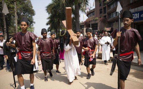Christian devotees takes part in a perform to re-enactment of the crucifixion of Jesus Christ