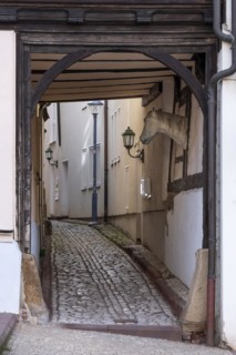 Narrow alley with cobblestones in the historic old town, Schlossgasse, passage through a