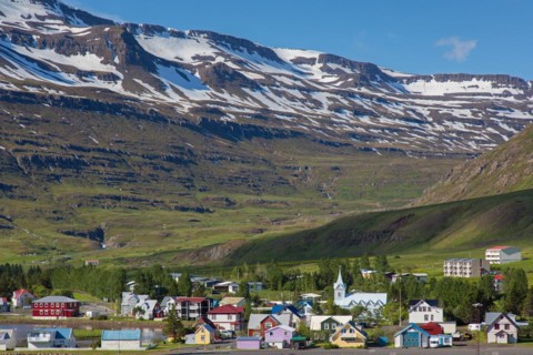View over church and colourful houses in the town Seyoisfjoerour along the fjord Seydisfjoerdur in