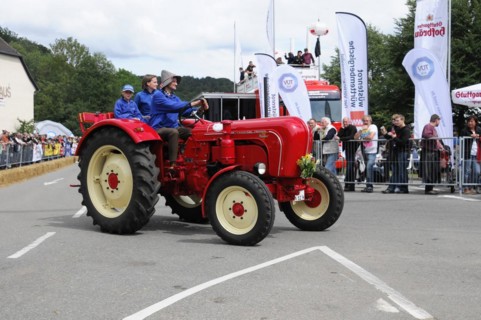 Porsche Diesel Tractors, A historic red tractor is proudly driven in a summer parade, SOLITUDE