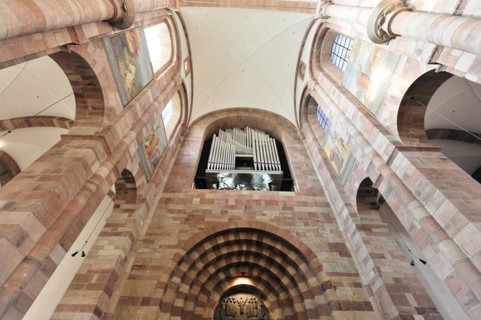 Speyer Cathedral, view of the organ and the high vault of a church with light streaming through the