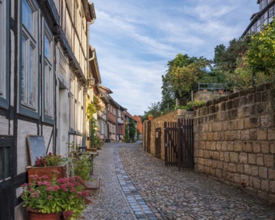Narrow alley with half-timbered houses and cobblestones on the castle hill in the historic old