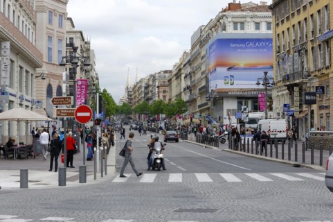 Marseille, A busy city street with people crossing the road and urban architecture, Marseille,