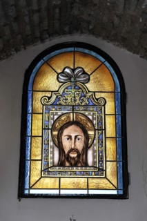 Castillo de Santa Catalina in Jaen, artistic stained glass window with a portrait of Jesus,