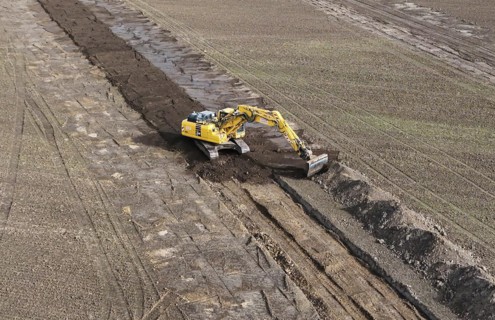 Excavators begin preparations for the construction site access road on the L 50 at the future Intel