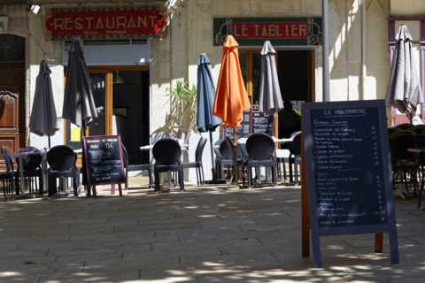 Marseille, Empty street cafe with closed parasols and a menu board next to it, Marseille,