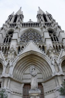 Church of Saint-Vincent-de-Paul, The facade of a Gothic church with detailed sculptures against a
