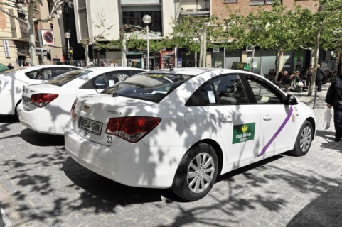 Jaen, row of white taxis waiting for passengers in a city street, Jaen, Andalusia, Spain, Europe
