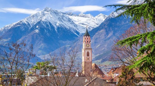 Tower of the parish church with the peak 3006m in the Texel Group in spring, Merano, Val Passiria,