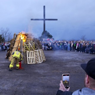 The fire brigade lights the Easter bonfire on the Haniel spoil tip in front of the summit cross,