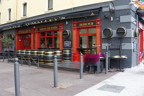 Marseille, Facade of an Irish pub with red colour and barrels in front of the entrance, Marseille,