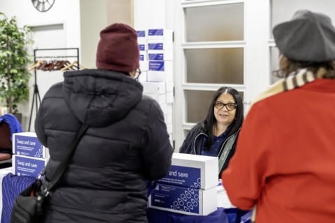 Detroit, Michigan, A representative for DTE Energy hands out energy-saving LED light bulbs at a