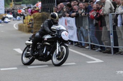 A motorcyclist races past spectators on a closed-off race track, SOLITUDE REVIVAL 2011, Stuttgart,