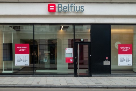 Office window showing opening hours of Belfius bank branch in the city Ghent, East Flanders,