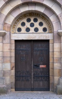 Slogan All and in all Christ above a door of St Mary's Cathedral, Havelberg, Saxony-Anhalt,
