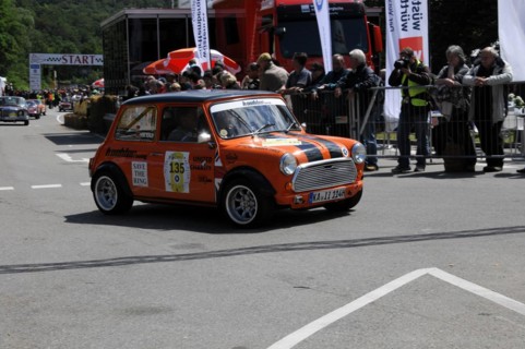An orange and black Mini Cooper starts on a rally surrounded by spectators, SOLITUDE REVIVAL 2011,
