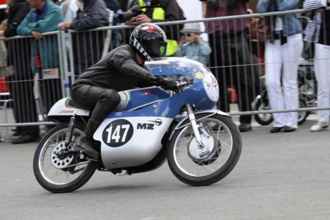 A focussed motorbike racer during a race in front of spectators, SOLITUDE REVIVAL 2011, Stuttgart,