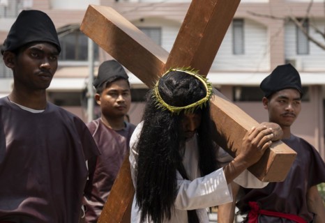 Christian devotees takes part in a perform to re-enactment of the crucifixion of Jesus Christ