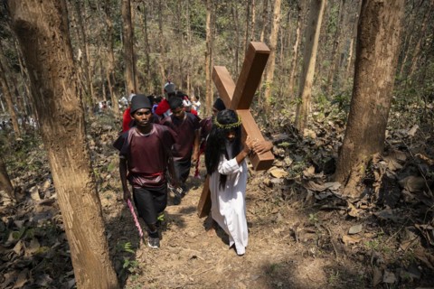 Christian devotees takes part in a perform to re-enactment of the crucifixion of Jesus Christ