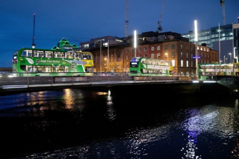 Buses cross the River Liffey at night. Dublin, Ireland, Europe
