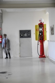 Deutsches Automuseum Langenburg, Old red Shell petrol pump next to a motorbike replica in a museum,