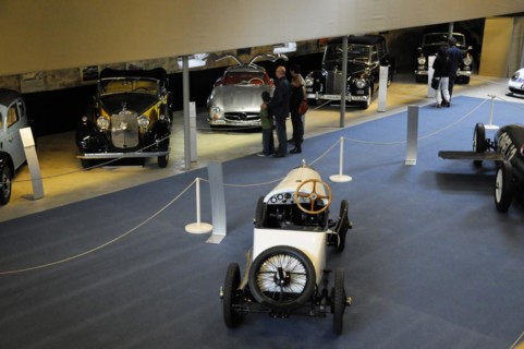 German Car Museum Langenburg, Interior view of a car museum with visitors and various vintage cars,