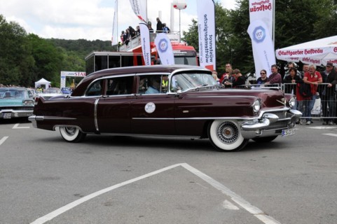 Burgundy red Cadillac classic car drives past a crowd at an event, SOLITUDE REVIVAL 2011,