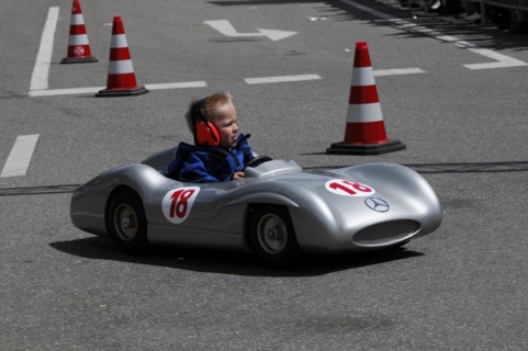 Child concentrates while driving a racing soapbox on a road course, SOLITUDE REVIVAL 2011,