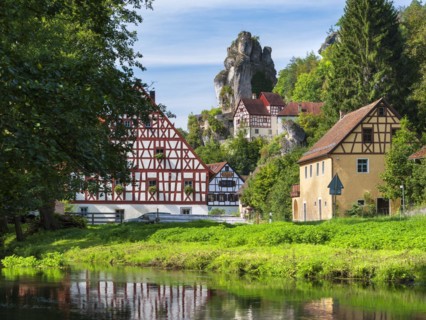 Zechenstein rock formation and half-timbered houses on the Puettlach river, rock castle and