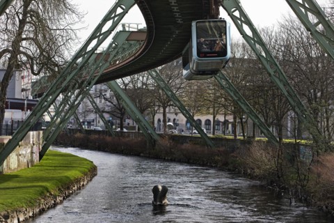 Suspension railway and sculpture by Bernd Bergkemper in the river Wupper commemorating the jump of