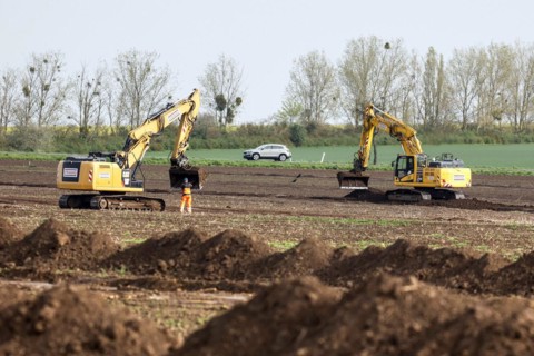 Excavators begin preparations for the construction site access road on the L 50 at the future Intel