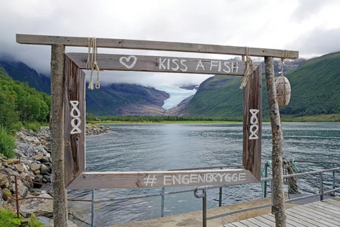 View of glacier tongue and lake through a wooden window, Svartisen, Kystriksveien, FV 17, Norway,