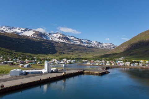 View over harbour and town Seyoisfjoerour along the fjord Seydisfjoerdur in summer, Eastern Region,