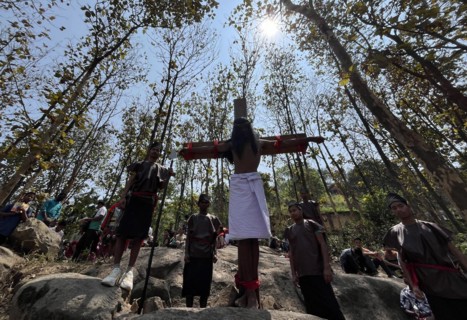 Christian devotees takes part in a perform to re-enactment of the crucifixion of Jesus Christ